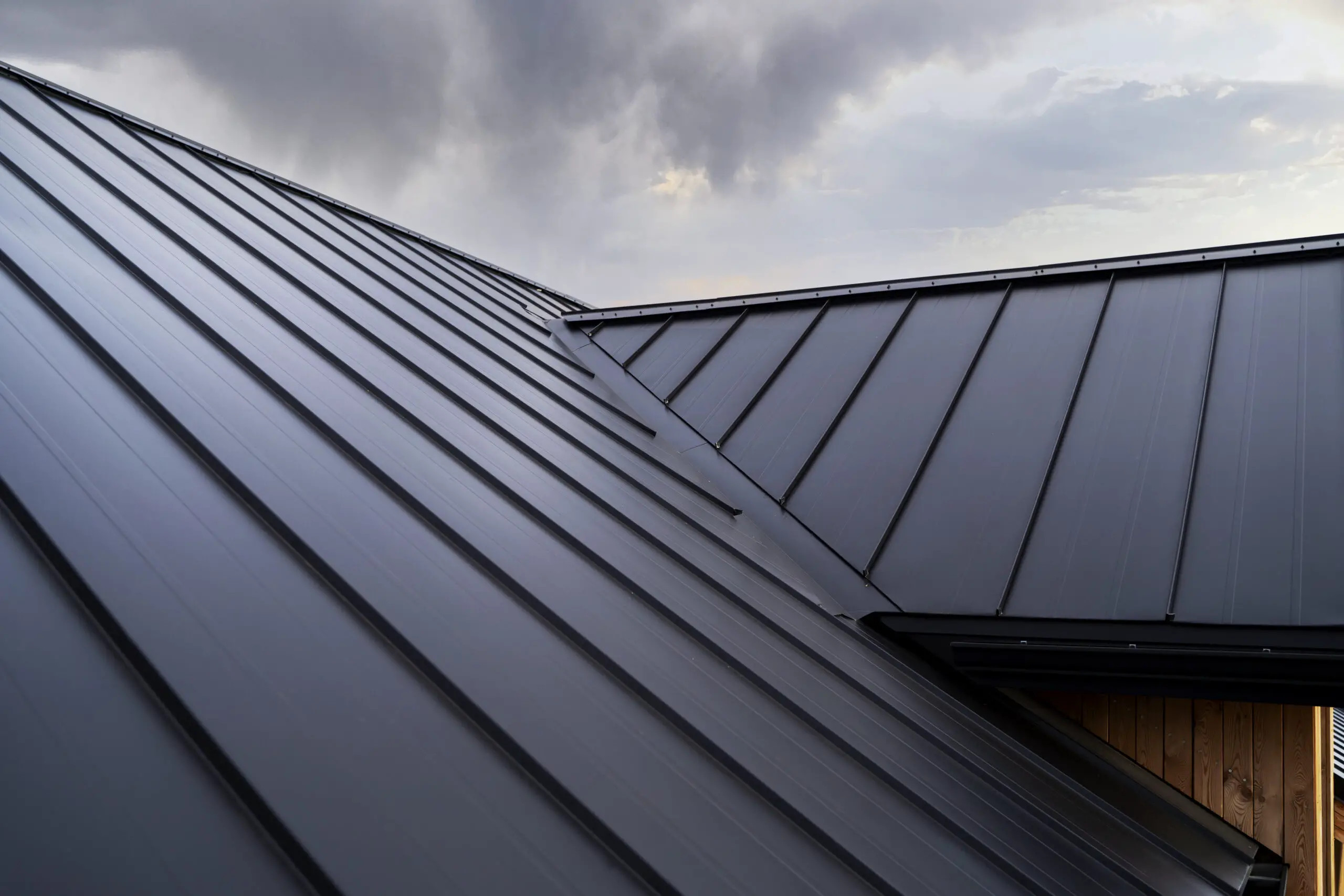 low angle modern house roof 1 scaled Understanding the True Cost of Metal Roof
