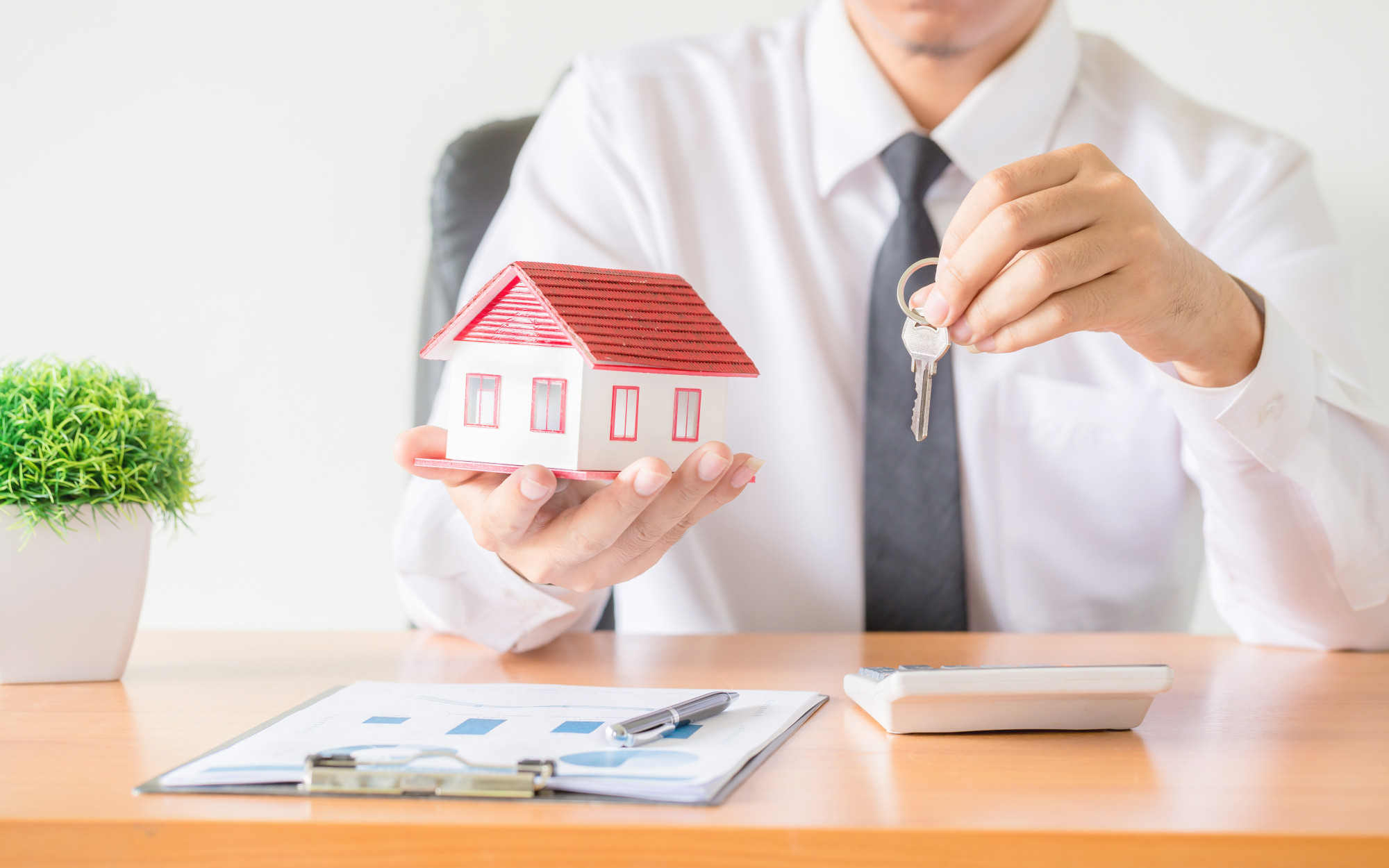 house key home insurance broker agent s hand protection Buying vs. Renting: The Pros and Cons of Real Estate Ownership